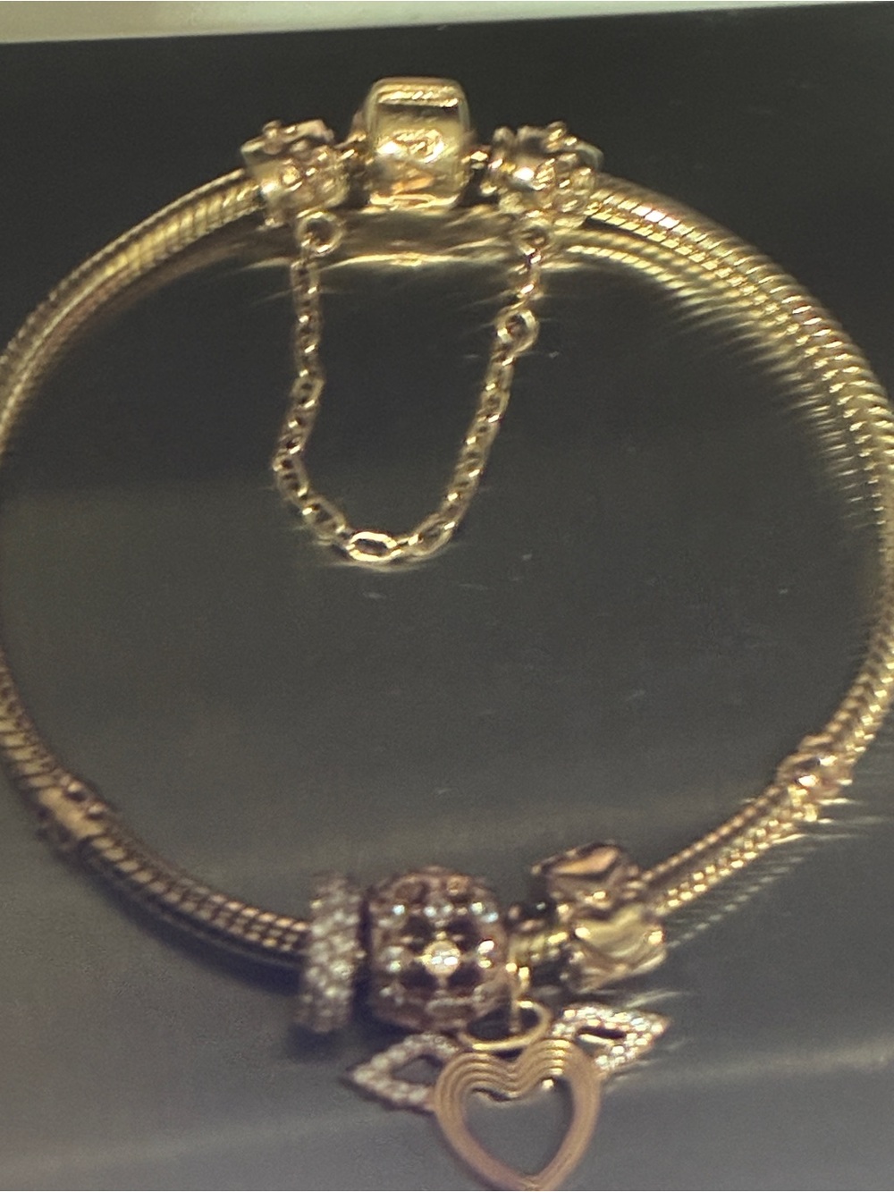Pandora solid gold 14k gold bracelet with 4 14k gold charms and the safety chain